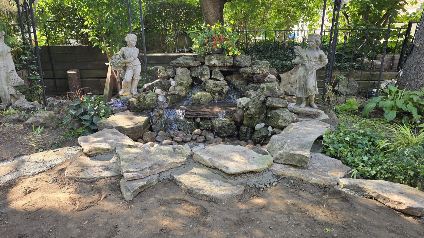 Tropic Ponds koi pond with clear water and stone border